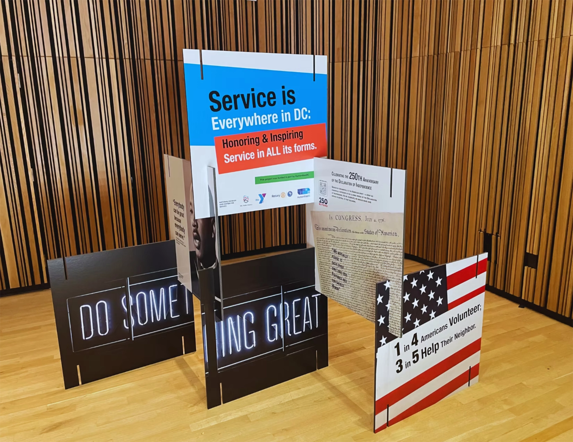 Arranged signs at exhibit showing title "Service is Everywhere in DC" along with signs showing the Declaration of Independence and MLK Jr.
