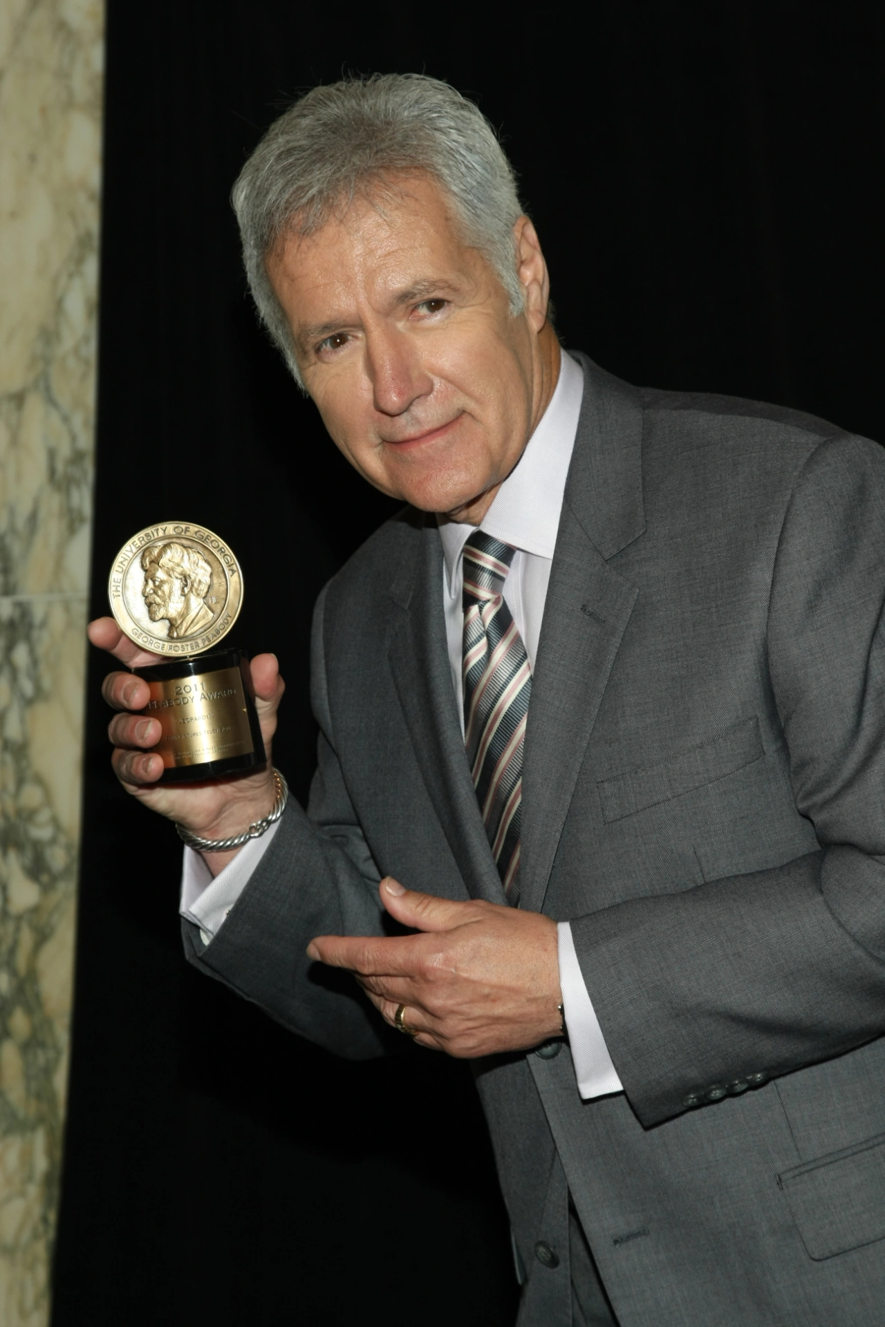 Alex posing with Peabody Award