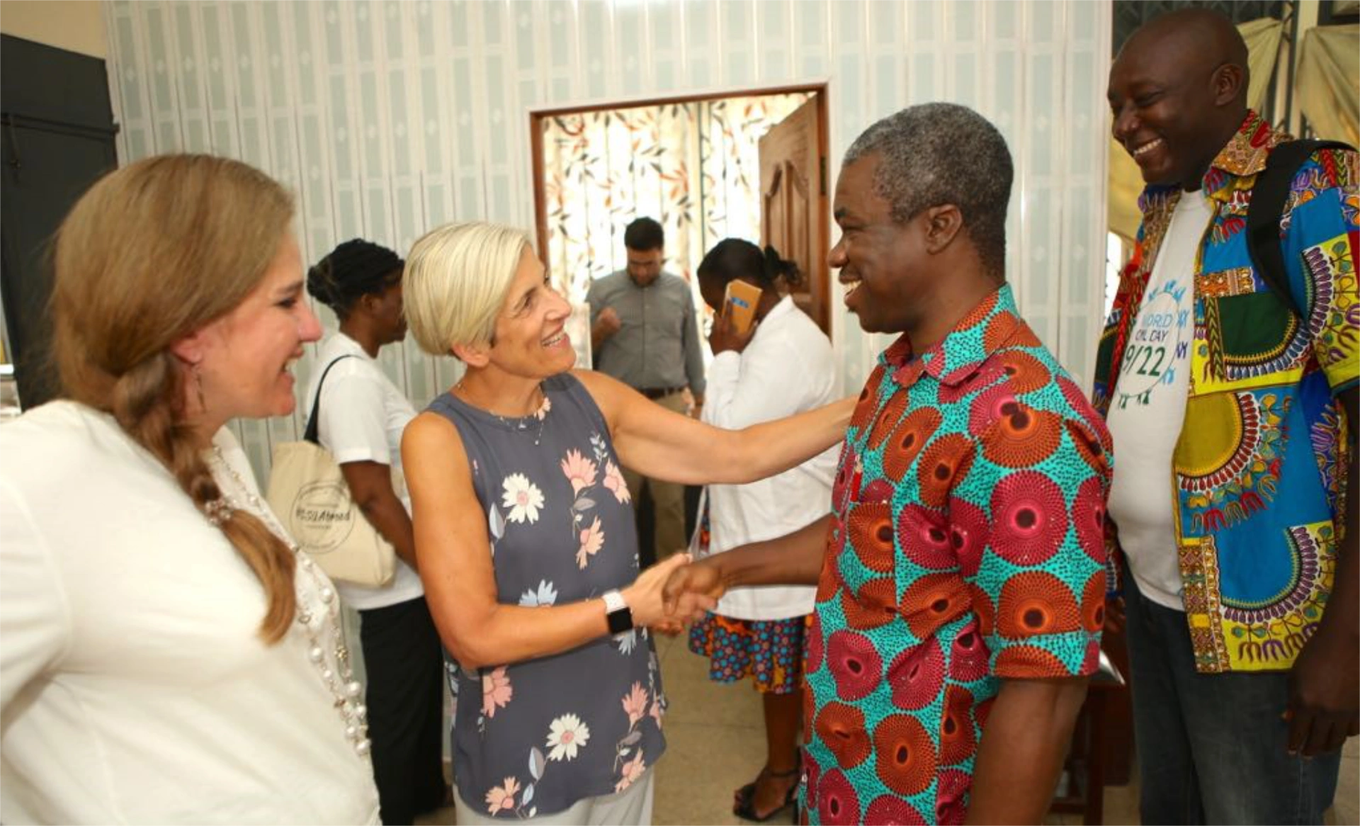 Pat shaking hands with person at event