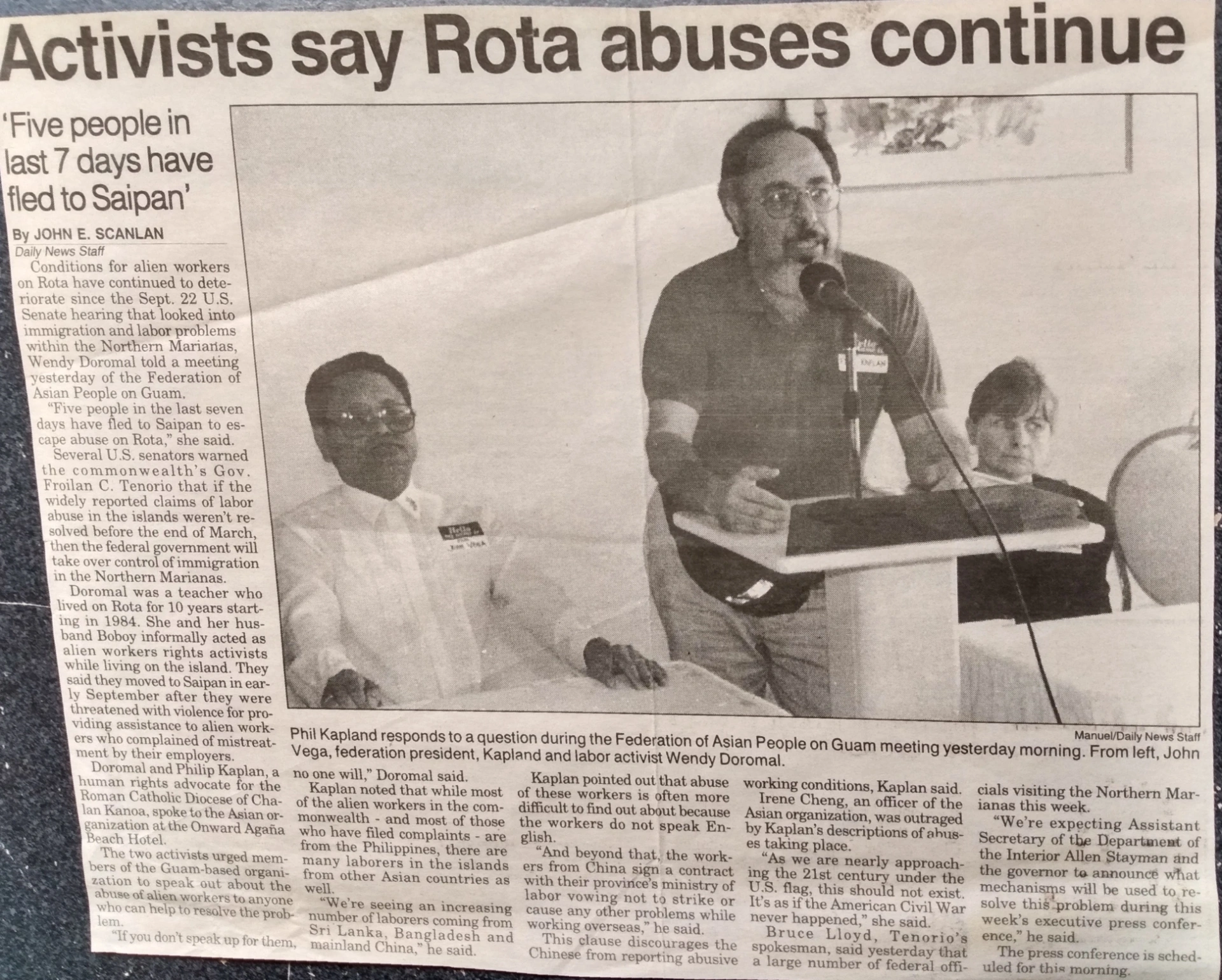 Newspaper clipping with photo of Phil speaking at meeting with headline “Activists say Rota abuses continue”