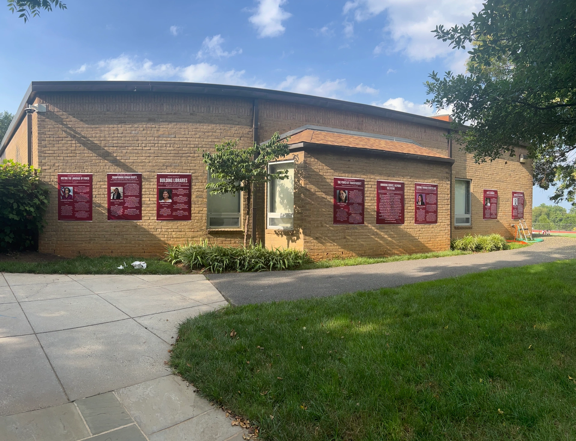 Signs for service museum arranged in a series on exterior of Sidwell Friends School