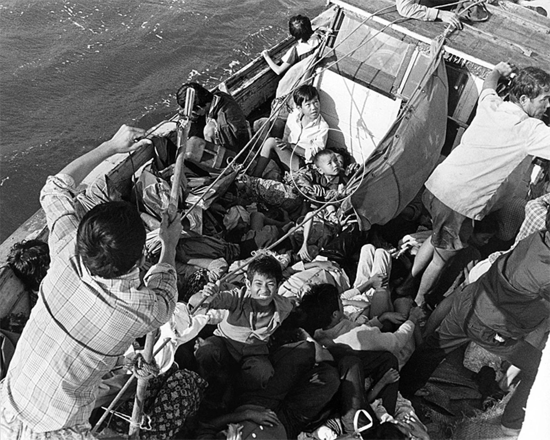 3-year-old Vinh with family on rescue ship