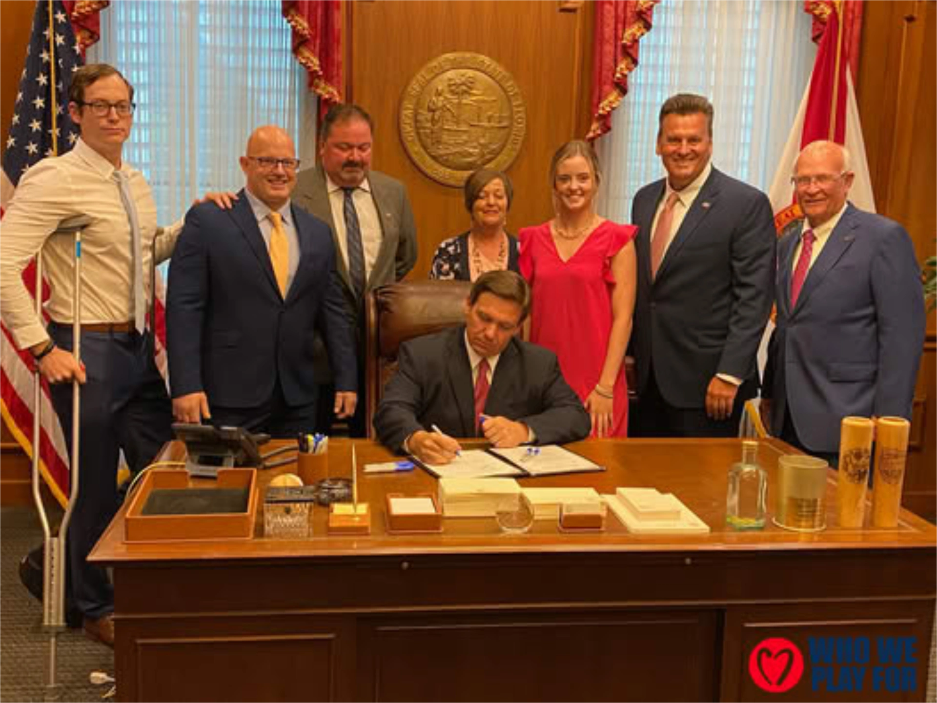 Who We Play For representatives at bill signing with Governor Ron DeSantis