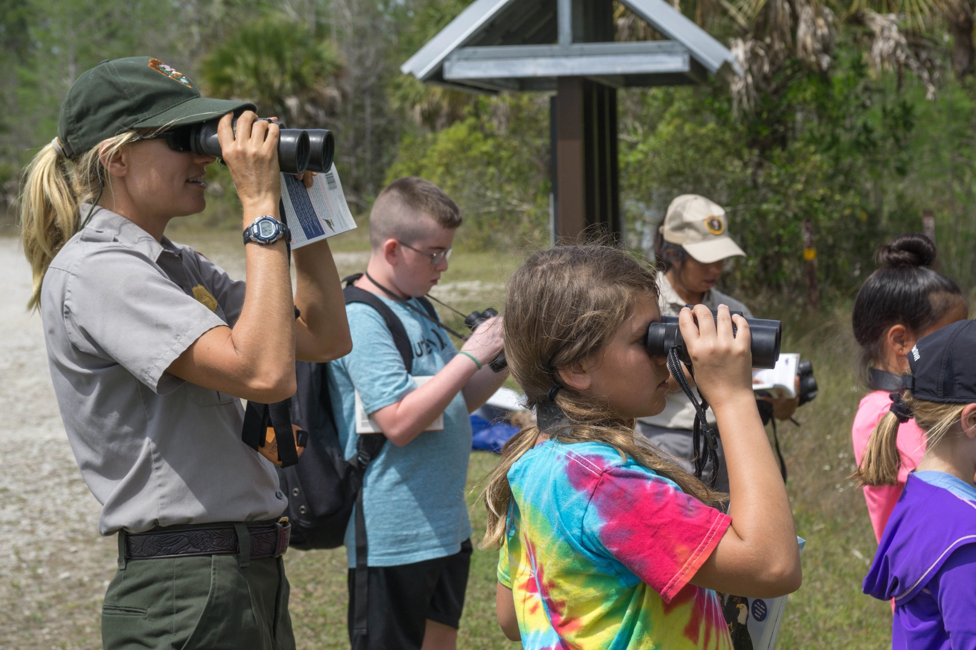 National Park Service ranger teaching a group of children at a park