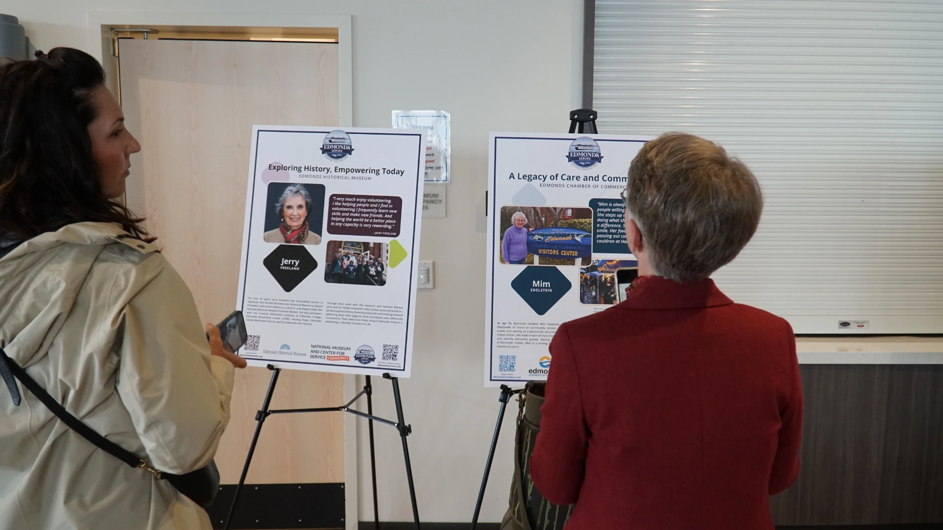 Two women reading exhibit signs at Edmonds, WA community museum of service