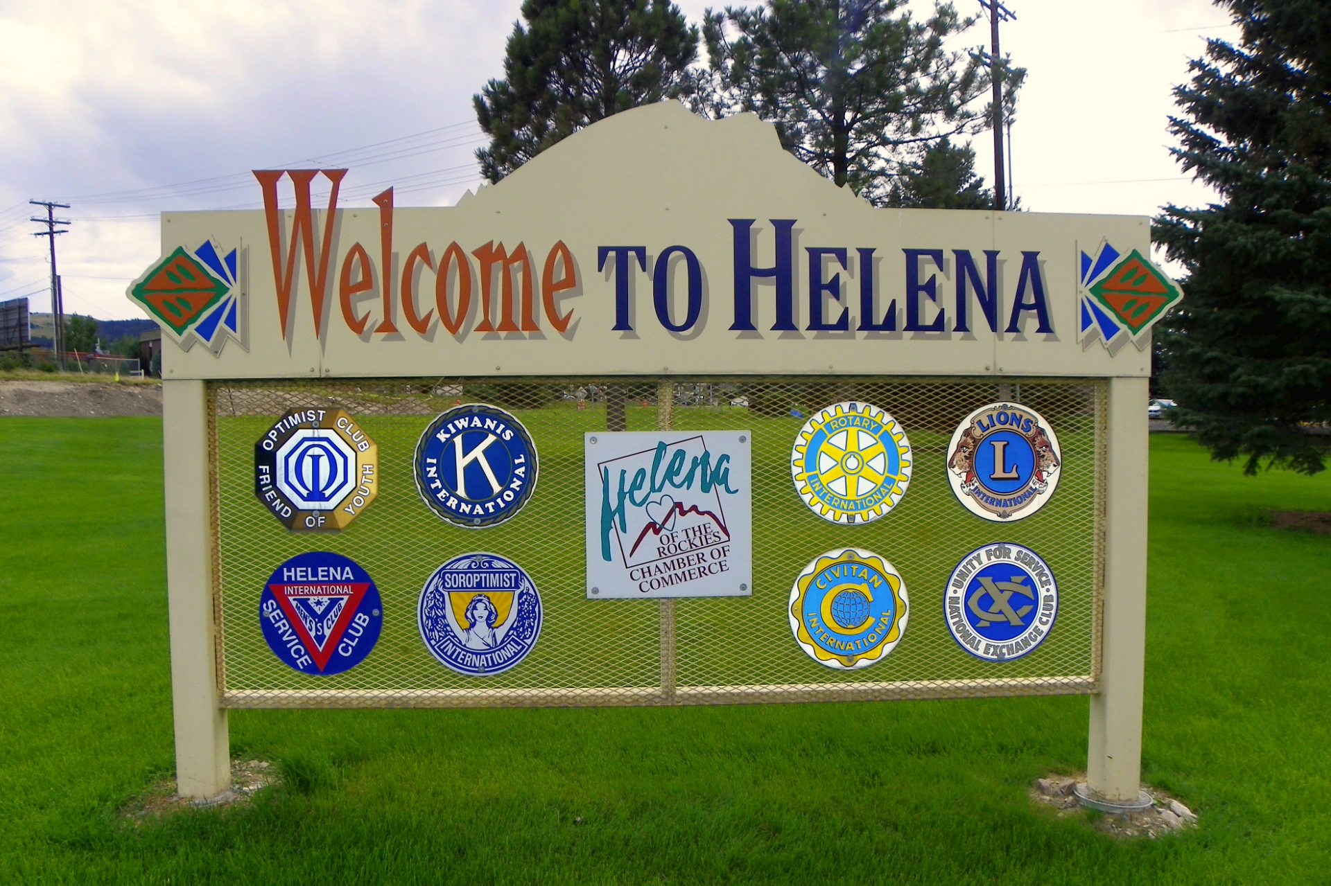 Welcome to Helena sign outside with logos of different service organizations on display